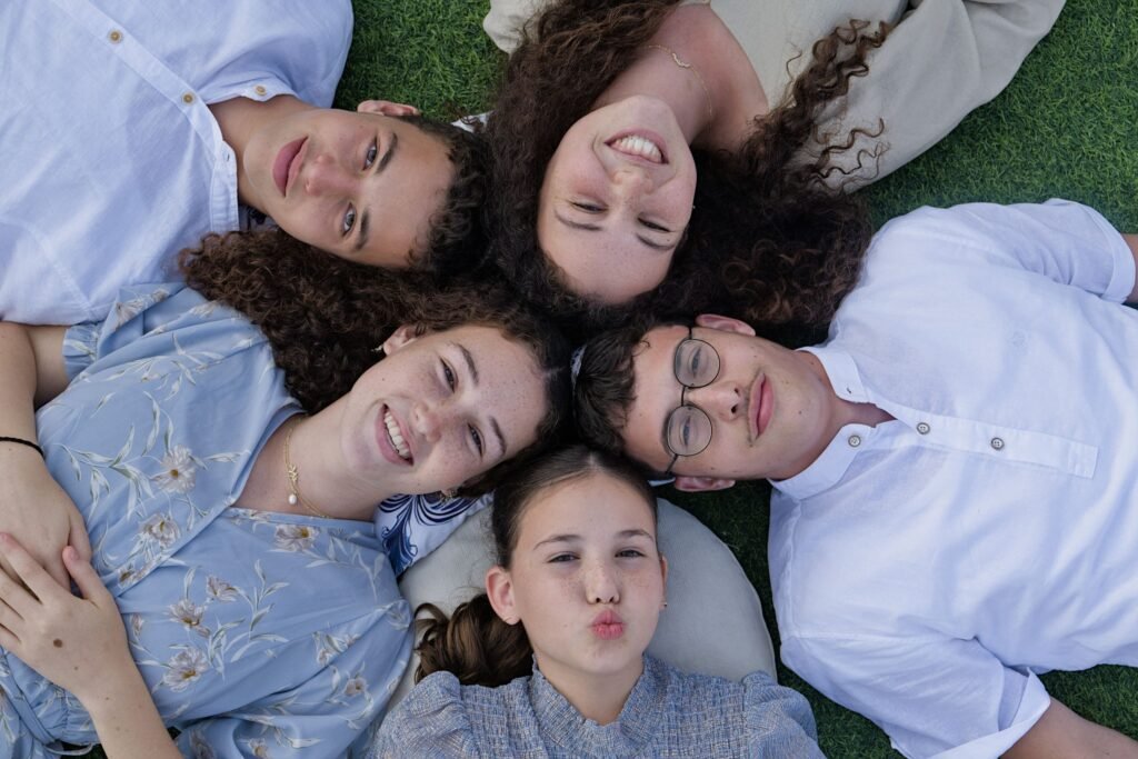 Portrait image of kids laying on the grass