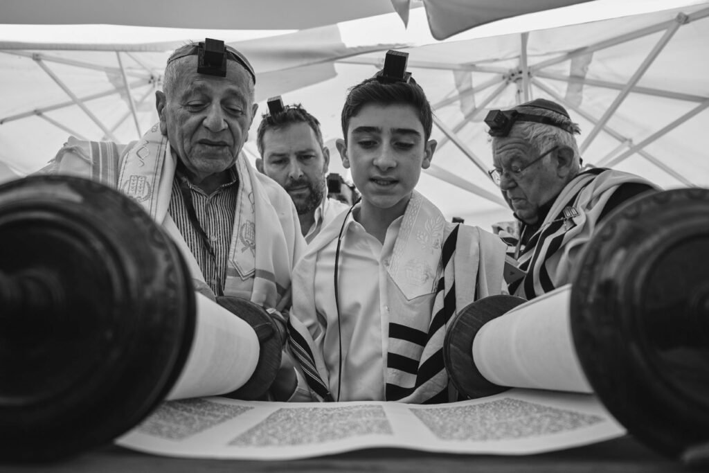 A boy reading from the Torah at his bar mitzva - event photography