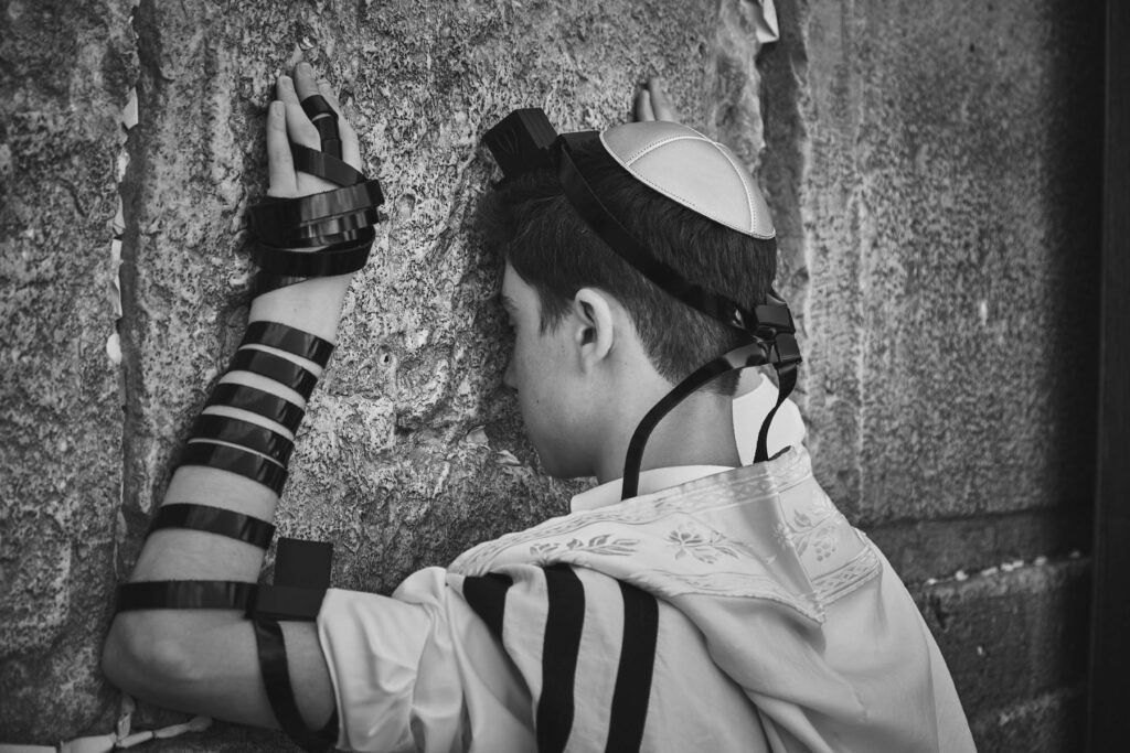 a boy kissing the western wall - event photography in jerusalem