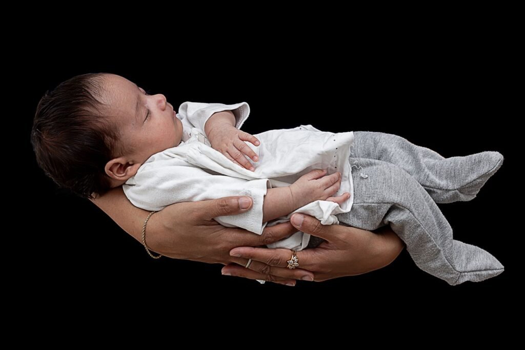 Baby photography, a newborn photography over a black background
