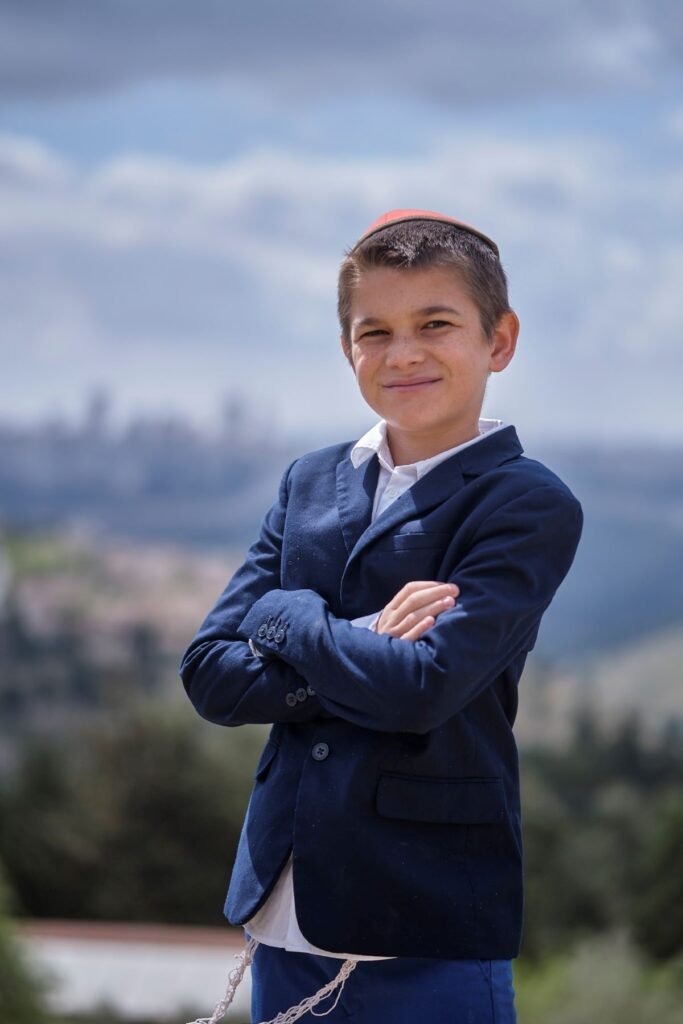 A portrait photo of a jewish boy wearing a suit