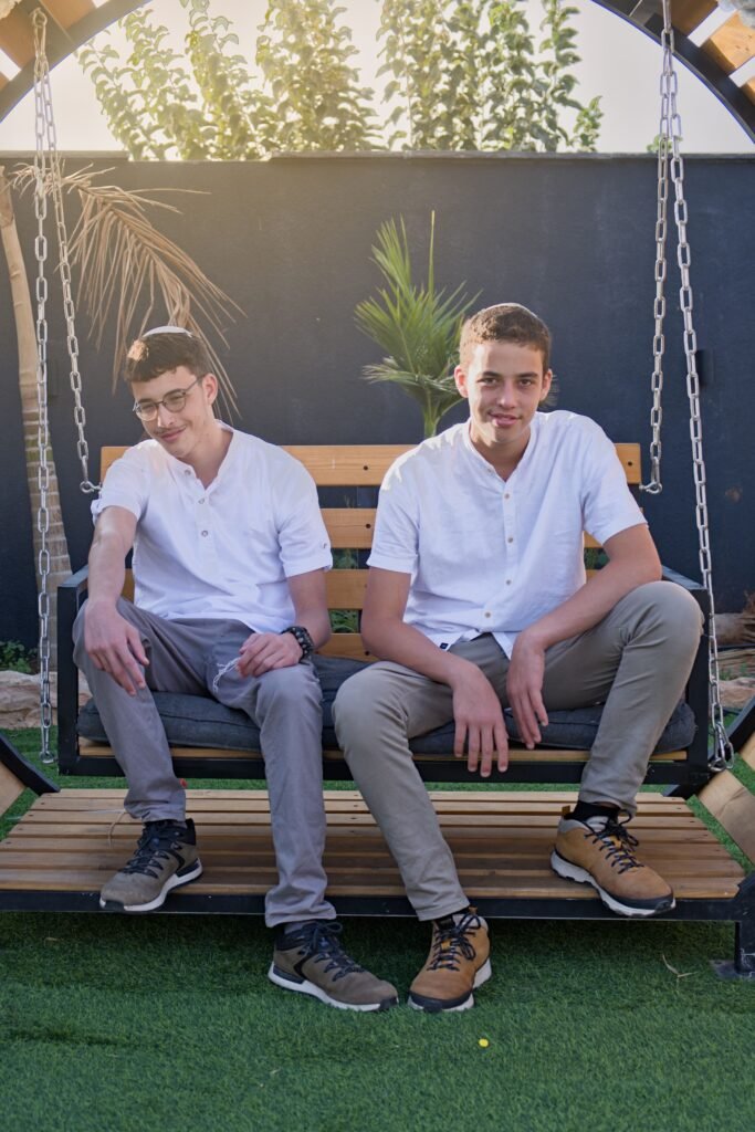 Two Brothers sitting on a deck and posing for portrait photography